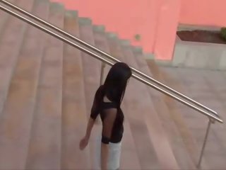 Suri angelic brunette babe flashing pussy in a public place on the stairs